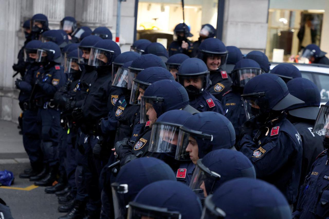 Austrian police officers guard a protest against an international gas conference in Vienna