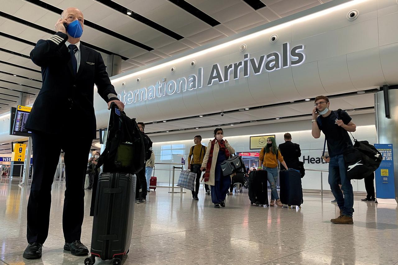 A member of aircrew is seen wearing a protective  face mask at Heathrow Airport, as Britain launches its 14-day quarantine for international arrivals, following the outbreak of the coronavirus disease (COVID-19), London, Britain