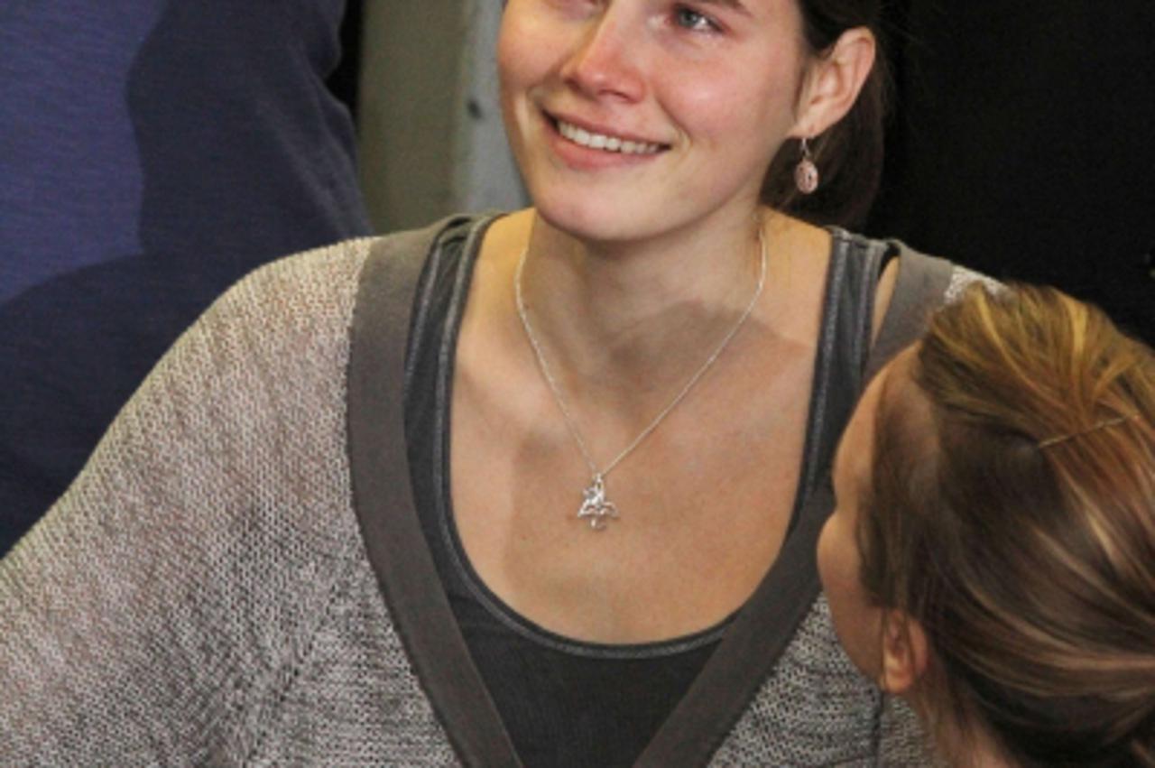 'Amanda Knox (L) is comforted by her sister, Deanna Knox, during a news conference shortly after her arrival at Seattle-Tacoma International Airport October 4, 2011, in Seattle.  US student Amanda Kno
