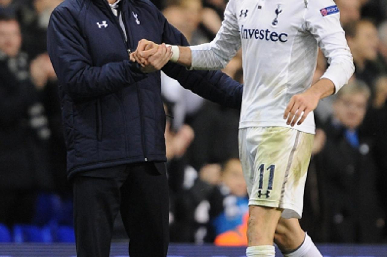 'Tottenham Hotspur manager Andre Villas-Boas (left) greets Gareth Bale (right) as he is substituted Photo: Press Association/Pixsell'
