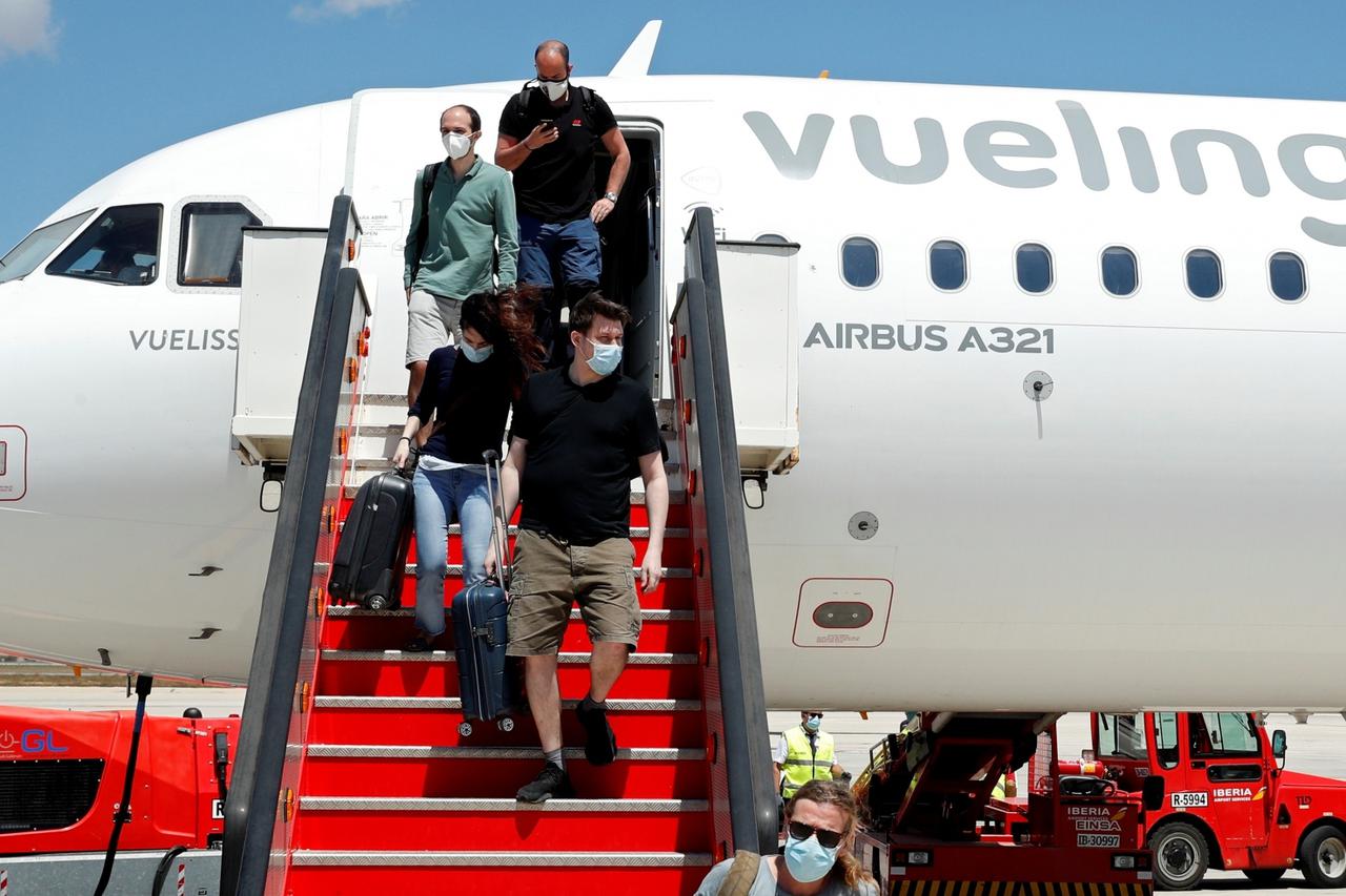 Passengers leave a Vueling plane upon their arrival at Palma de Mallorca airport on the Balearic Islands