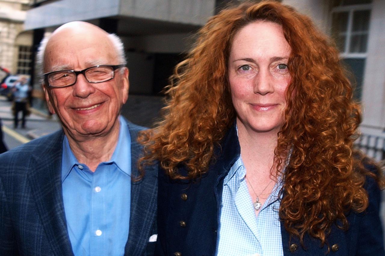 \'ATTENTION EDITORS: ALTERNATIVE CROP  Rebekah Brooks (R) Chief Executive of News International and Rupert Murdoch Chairman of News Corporation leave from his London residence shortly after his arriva