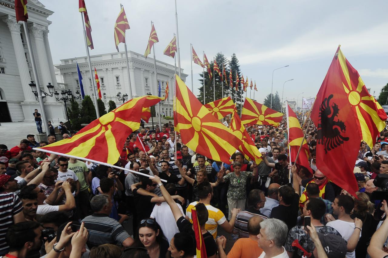 Protesters wave Macedonian and Albanian flags during an anti-government demonstration in front of the government building in Skopje, Macedonia, May 17, 2015. Tens of thousands of protesters took to the streets of  Macedonia's capital on Sunday, waving Mac