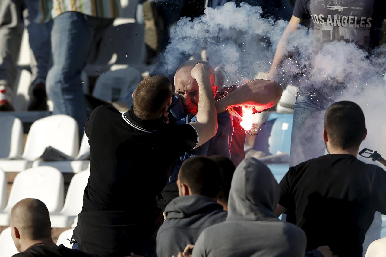 Red Star Belgrade and Partizan Belgrade fans clash in the stadium before the teams' Serbian Superliga soccer match in Belgrade, April 25, 2015. Serbian league leaders Partizan Belgrade held champions and bitter city foes Red Star to a 0-0 draw in a derby 