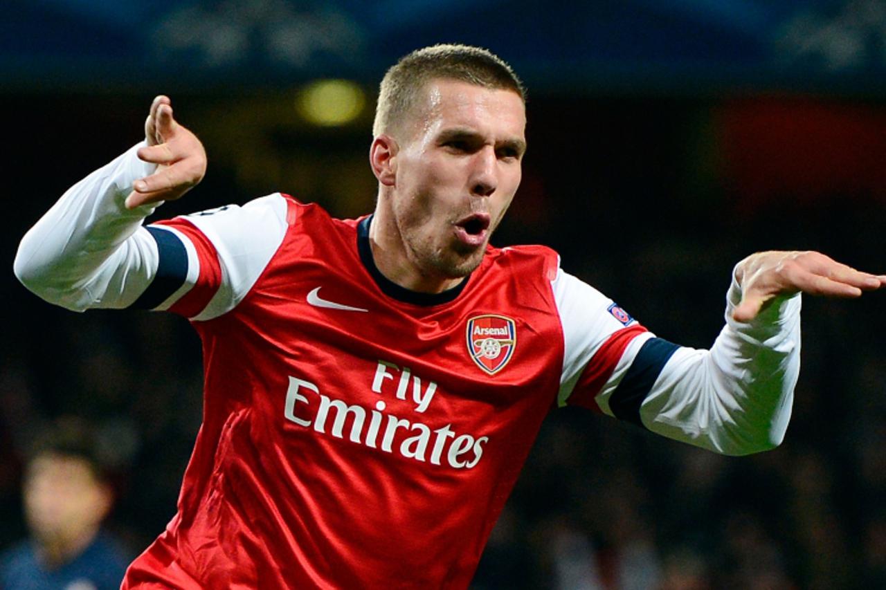 'Arsenal\'s German striker Lukas Podolski celebrates scoring his team\'s second goal during the UEFA Champions League group B football match against Montpellier at the Emirates Stadium, North London, 