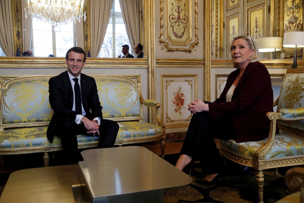 FILE PHOTO: French President Emmanuel Macron attends a meeting with French far-right National Rally (Rassemblement National) party leader Marine Le Pen at the Elysee Palace in Paris