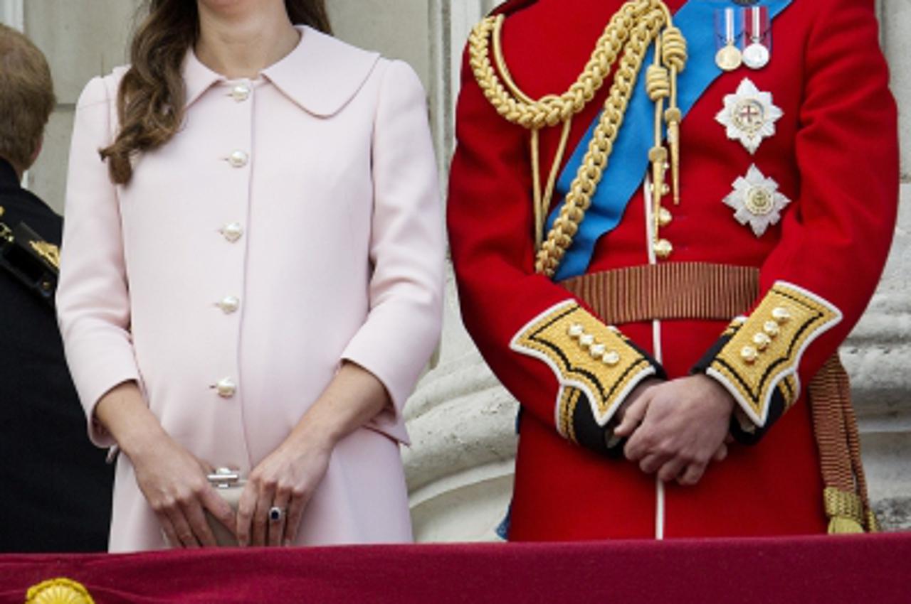 'Pregnant Catherine, Duchess of Cambridge, and Prince William, Duke of Cambridge seen on the balcony of Buckingham Palace to watch a flypast of military aircraft following Trooping the Colour in Londo