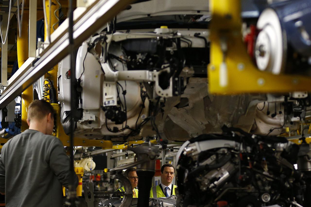 Britain's Chancellor of the Exchequer George Osborne looks at a car on the production line at Bentley Motors in Crewe