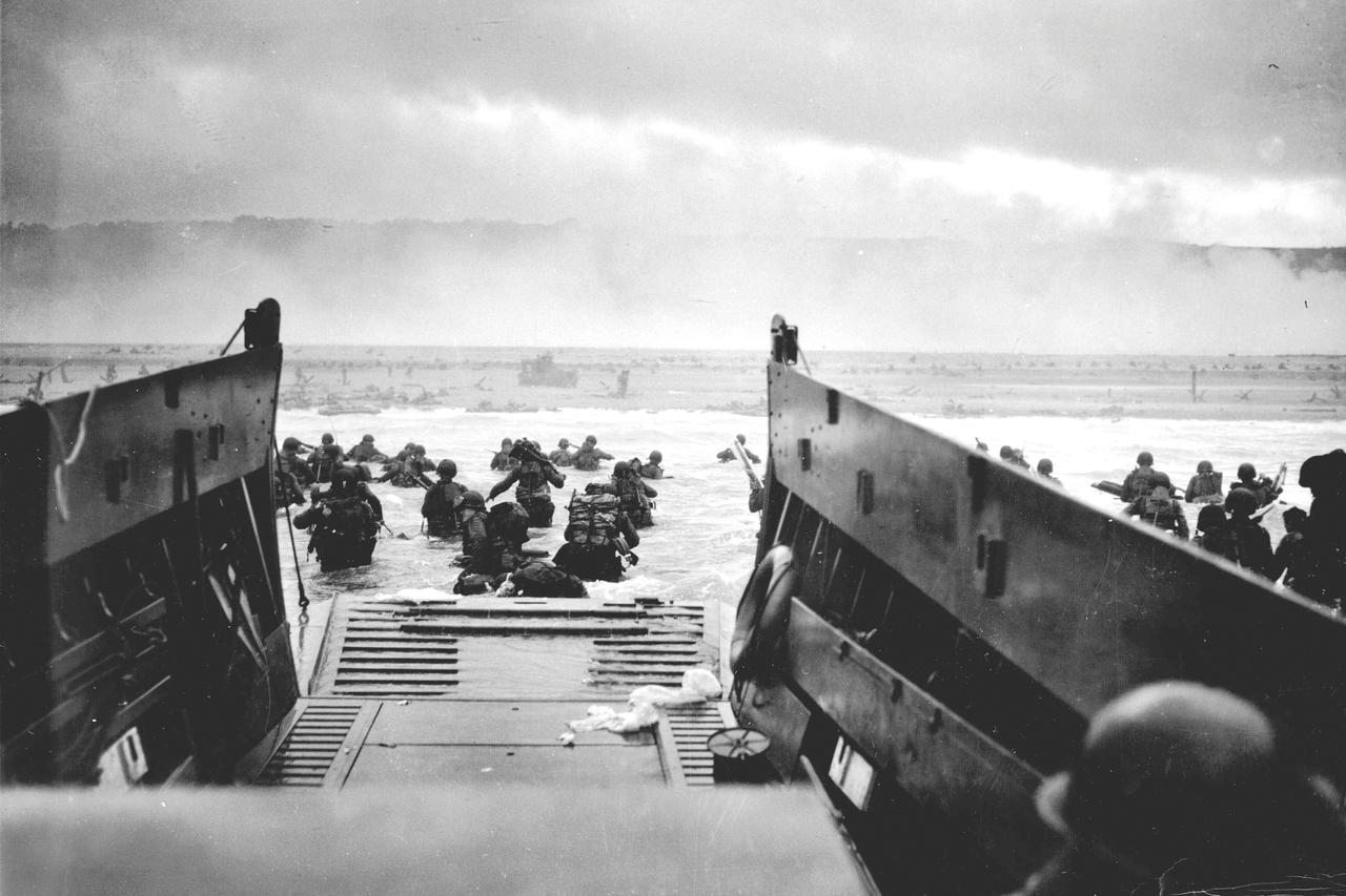 U.S. troops wading ashore from a Coast Guard landing craft at Omaha Beach during the Normandy D-Day landings near Vierville sur Mer