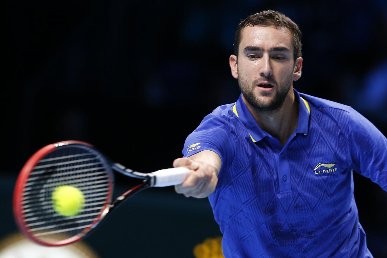 Marin Cilic of Croatia returns the ball to Tomas Berdych of the Czech Republic during their tennis match at the ATP World Tour finals at the O2 Arena in London November 12, 2014. REUTERS/Suzanne Plunkett (BRITAIN - Tags: SPORT TENNIS)