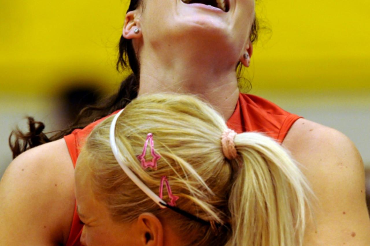 'Croatian Senna Usic Jogunica (top) hugs her teammate, Sanja Popovic as they celebrate their victory over Cuba during the Pool C match at the FIVB 2010 Women\'s Volleyball World Championships in Matsu