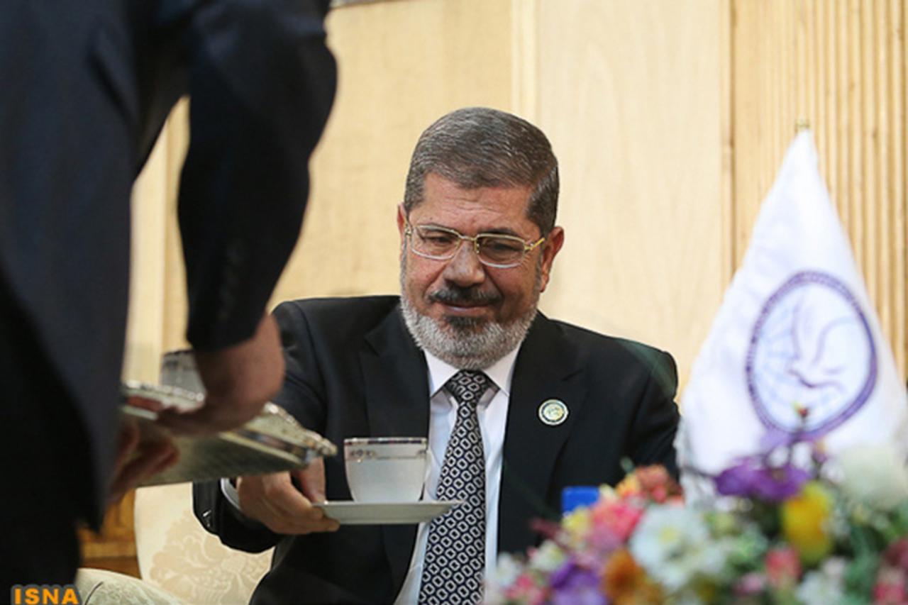 'Egypt's President Mohamed Mursi is seen before his meeting with Iran's Executive Vice President Hamid Baghai at Mehrabad airport in Tehran ahead of the 16th summit of the Non-Aligned Movement, Augu
