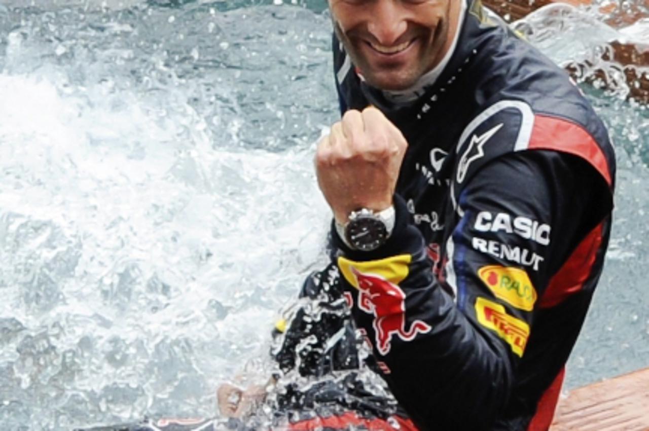 'Red Bull\'s F1 Formula One driver Mark Webber of Australia celebrates his victory at a pool after the finish of the Monaco F1 Grand Prix May 27, 2012.  REUTERS/Olivier Anrigo  (MONACO - Tags: SPORT M