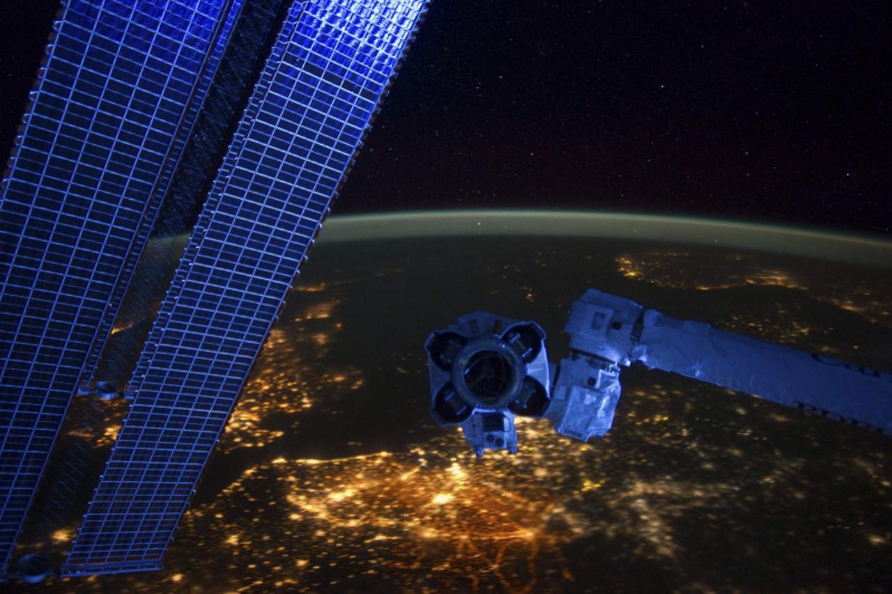 'A night-time view of a western European panorama reveals city lights from Belgium and the Netherlands behind a section of the earth-orbiting International Space Station in this January 22, 2012 hando