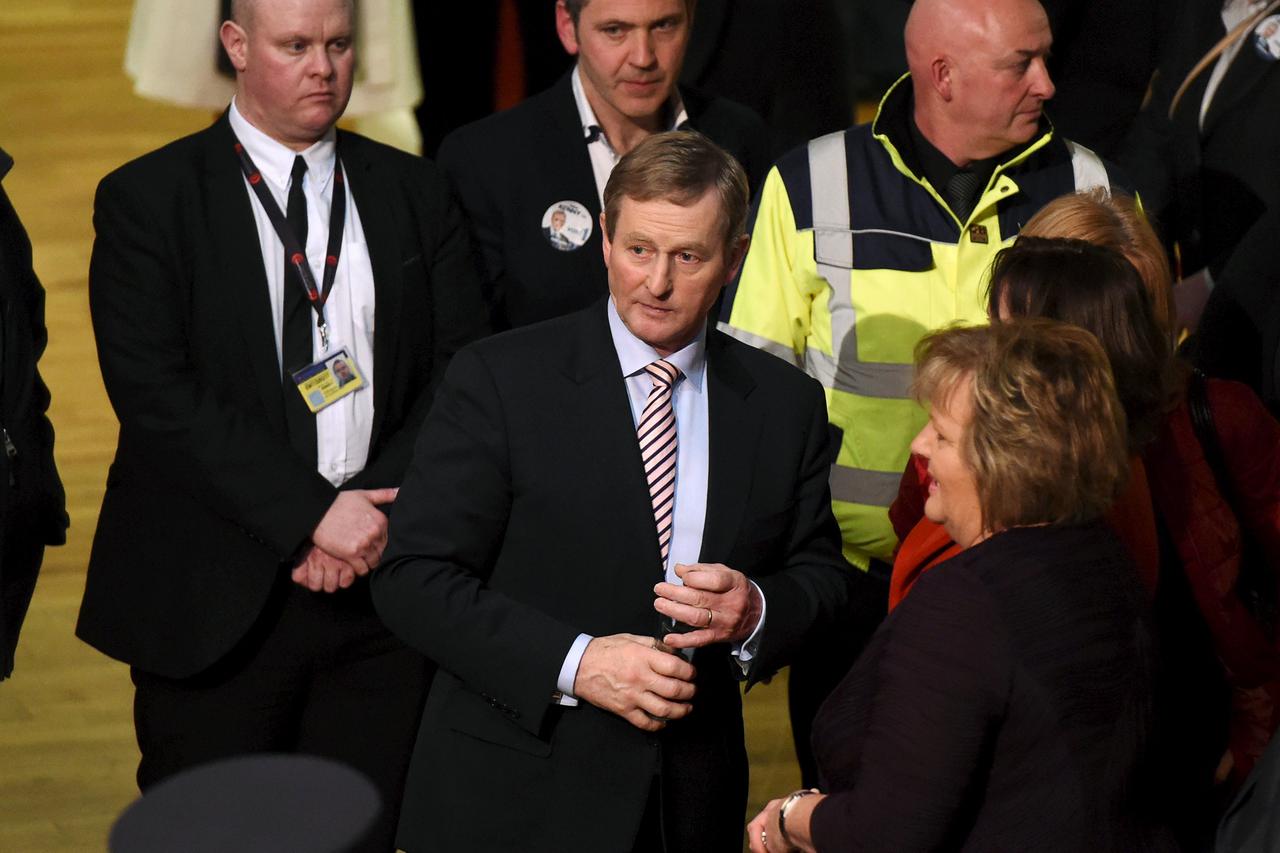 Irish Prime Minister Enda Kenny (C) departs the general election count at the count centre in Castlebar, Ireland February 27, 2016. REUTERS/Clodagh Kilcoyne