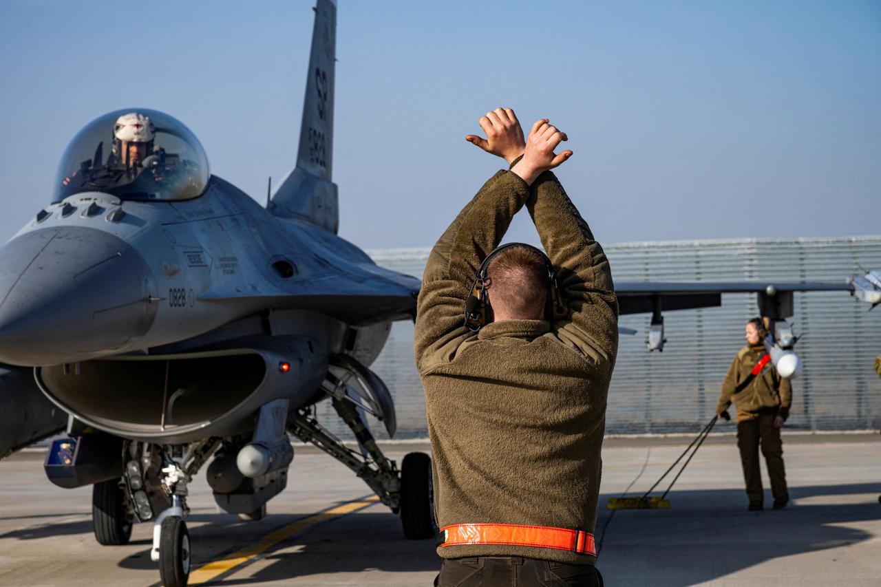 FILE PHOTO: FILE PHOTO: U.S. Air Force airman marshals an F-16 Fighting Falcon aircraft at the 86th Air Base Romania