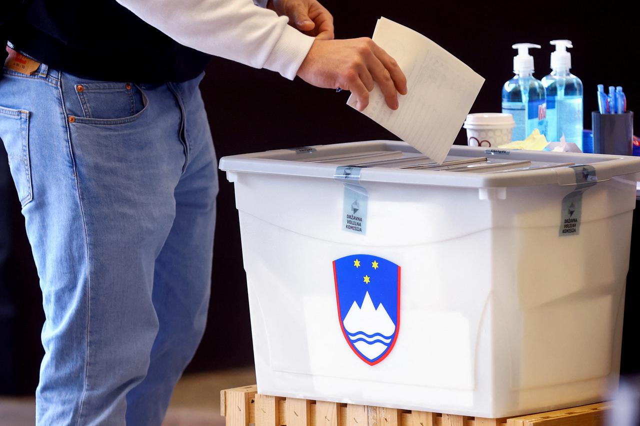 A man casts his vote at a polling station during parliamentary early voting in Ljubljana