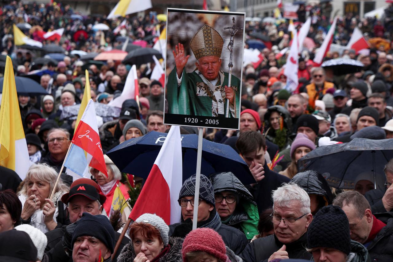 People march in defense of Pope John Paul II on his death anniversary in Warsaw