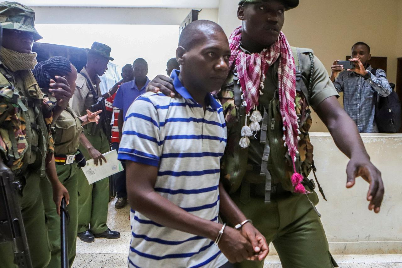 FILE PHOTO: Paul Mackenzie, a Kenyan cult leader accused of ordering his followers, who were members of the Good News International Church, to starve themselves to death in Shakahola forest, is escorted to the Malindi Law Courts