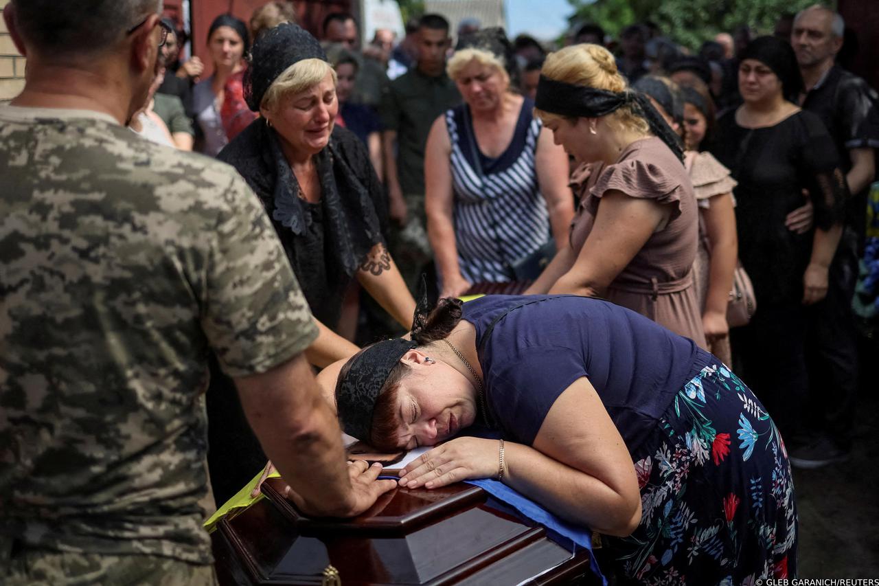 FILE PHOTO: A woman reacts during the funeral of Volodymyr Kochetov, 46, who was recently killed