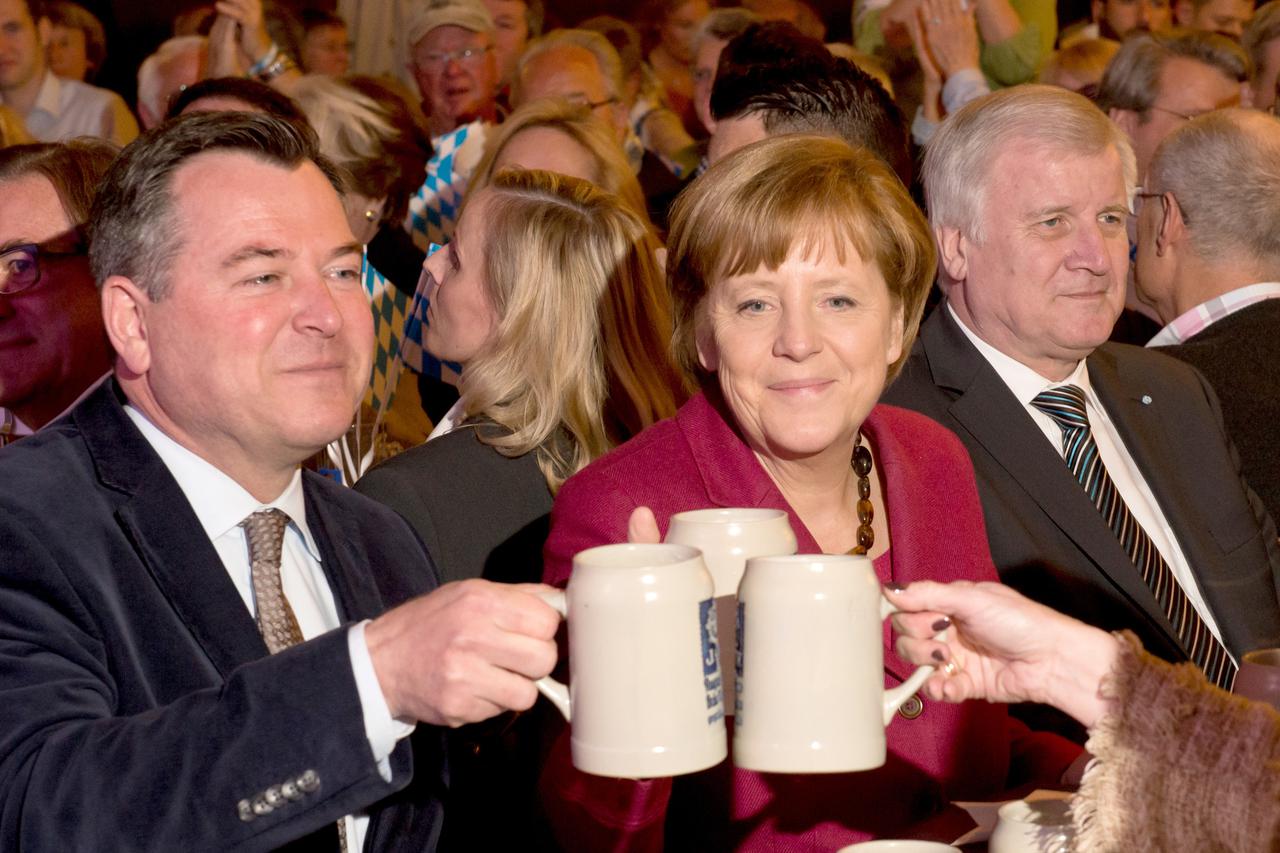 CSU candidate for Lord Mayor of Munich Josef Schmidt (L-R) and German Chancellor Angela Merkel toast beer mugs during the closing CSU campaign rally for Lord Mayor of Munich in Munich, Germany, 27 March 2014. Premier of Bavaria Horst Seehofer sits next to