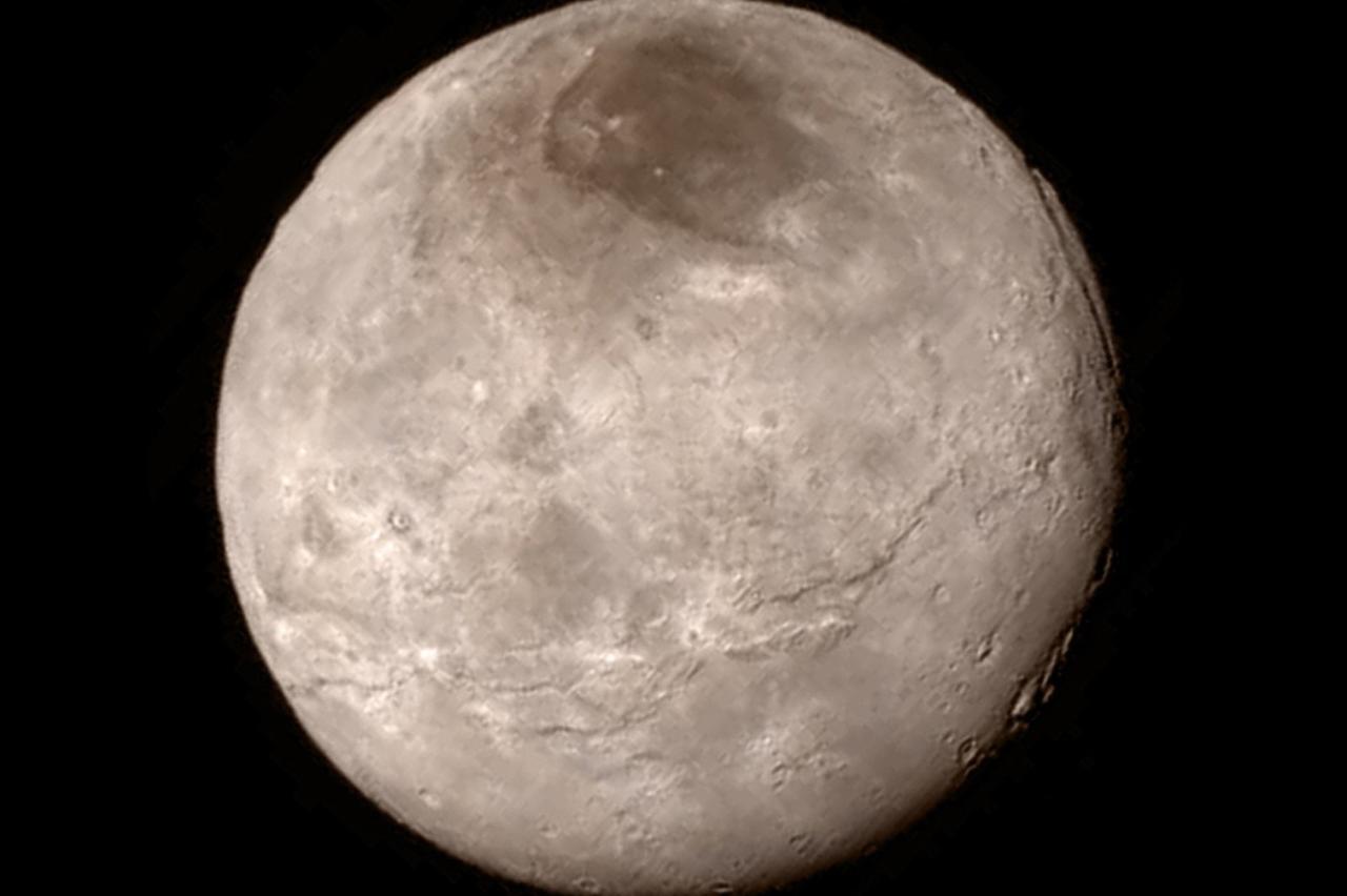 New details of Pluto?s largest moon Charon are revealed in this image from New Horizons? Long Range Reconnaissance Imager (LORRI), taken late on July 13, 2015 from a distance of 289,000 miles  (466,000 kilometers) in a picture released by NASA in Laurel, 