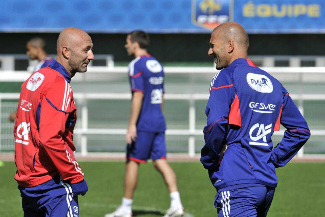 'French former football player Zinedine Zidane (R) looks at Fabien Barthez, former goalkeeper of France\'s World and European champion football team on September 1, 2010 in Clairefontaine, southern Pa