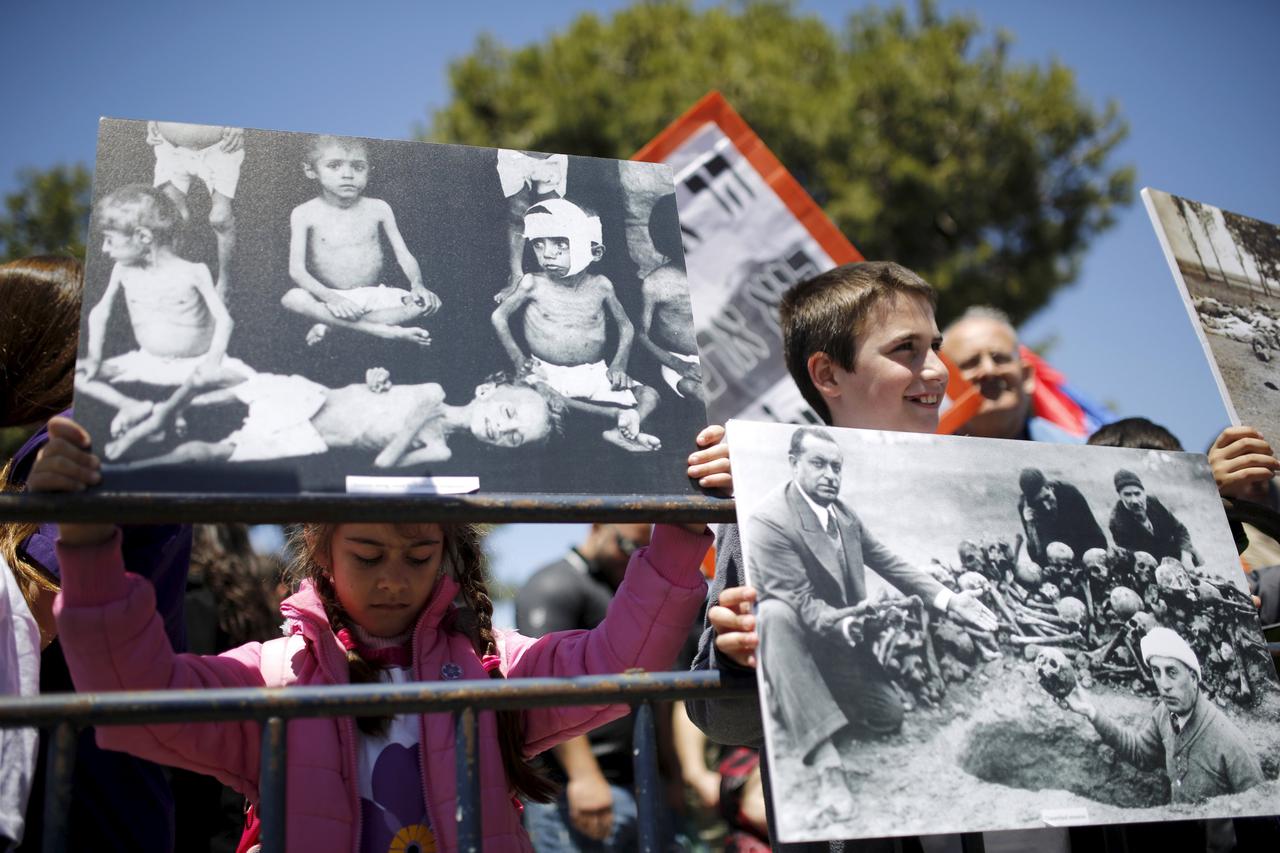 Children hold placards depicting the massacre of Armenians by Ottoman Turks  during a protest demanding that Turkey recognise the mass killing as a genocide, outside the Turkish consulate general in Jerusalem April 24, 2015. Hundreds of Armenians gathered