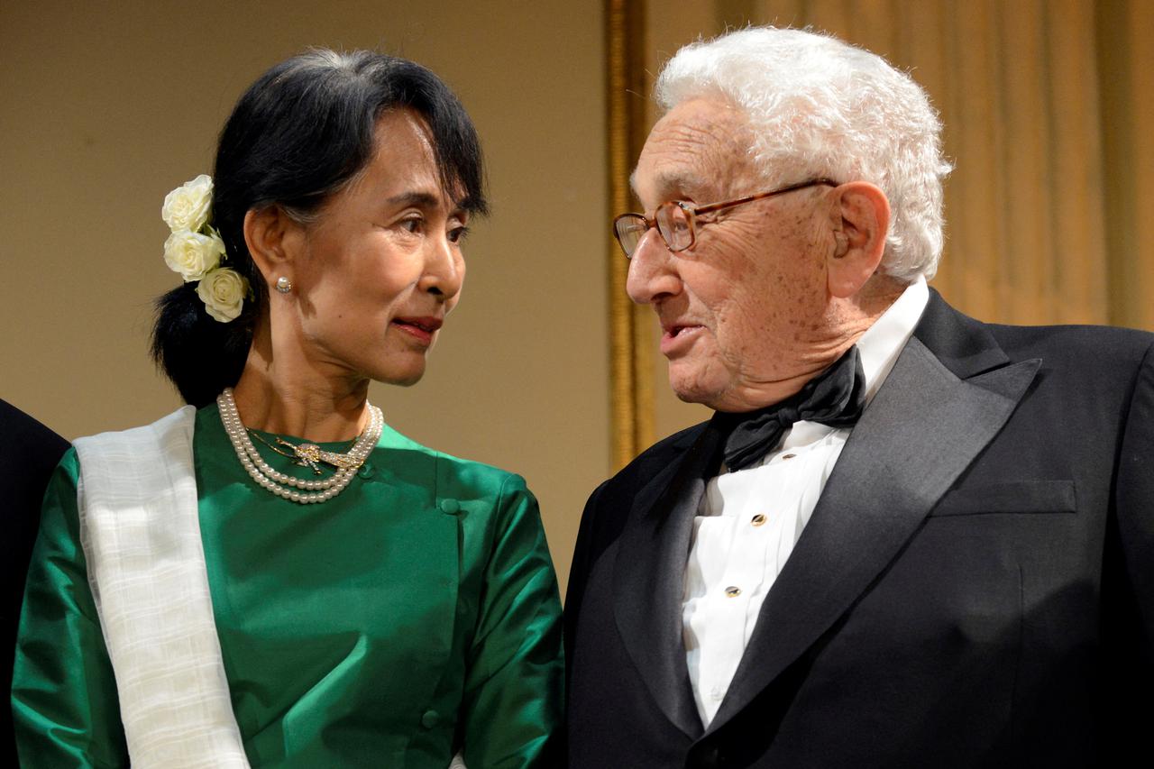 FILE PHOTO: Aung San Suu Kyi, chairperson of Myanmar's National League for Democracy, speaks with U.S. Secretary of State Henry Kissinger prior to the start of the third annual Global Citizen Awards Dinner in New York