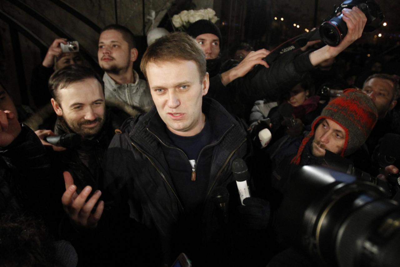 'Anti-corruption blogger Alexei Navalny speaks with journalists as he leaves a police station on the day of his discharge in Moscow, December 21, 2011. Navalny was arrested at an opposition protest in