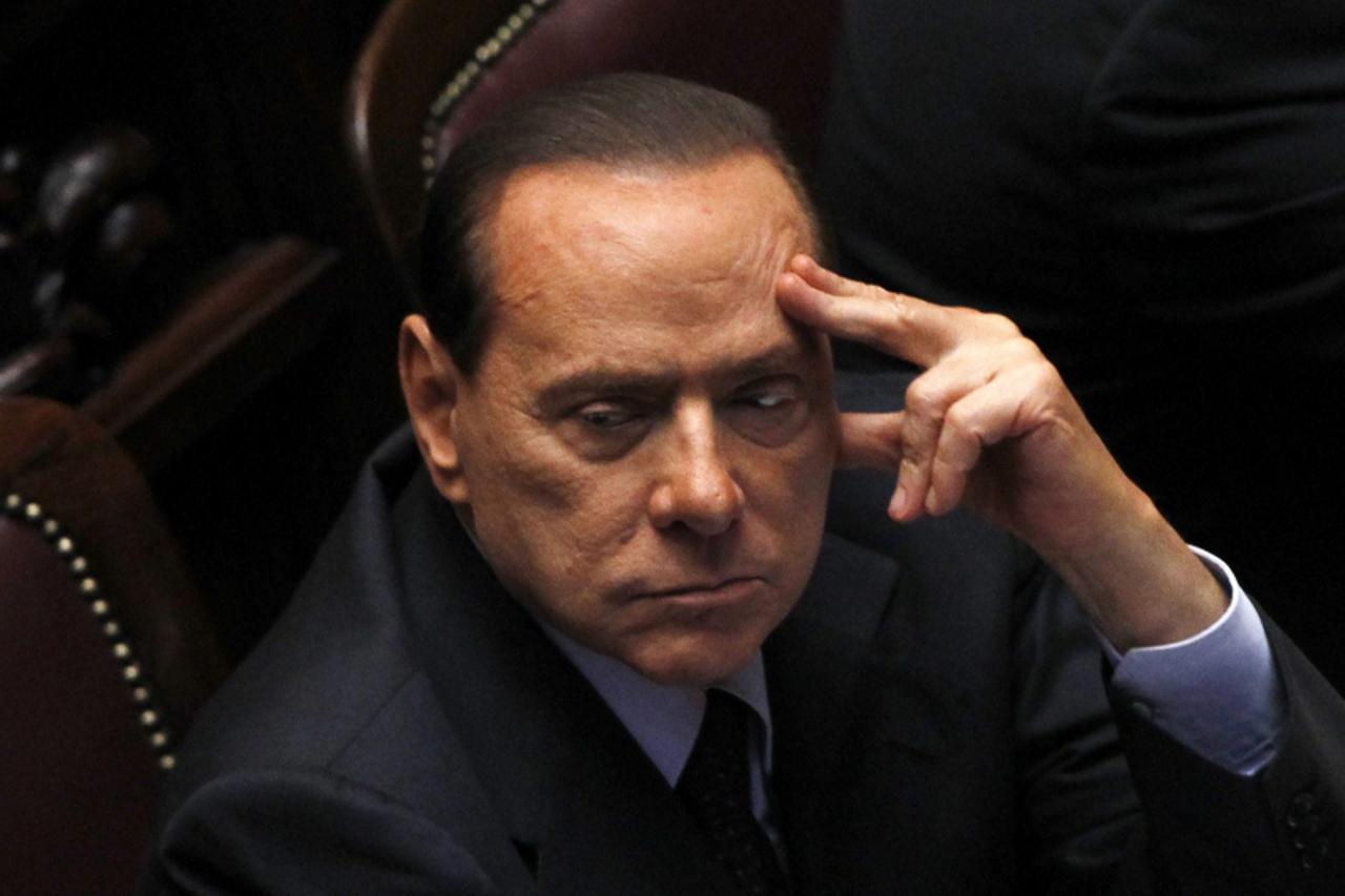 'Former Italian Prime Minister Silvio Berlusconi attends a debate at the lower house of parliament in Rome in this September 22, 2011 file photo. Italian prosecutors asked a Milan court to sentence Be