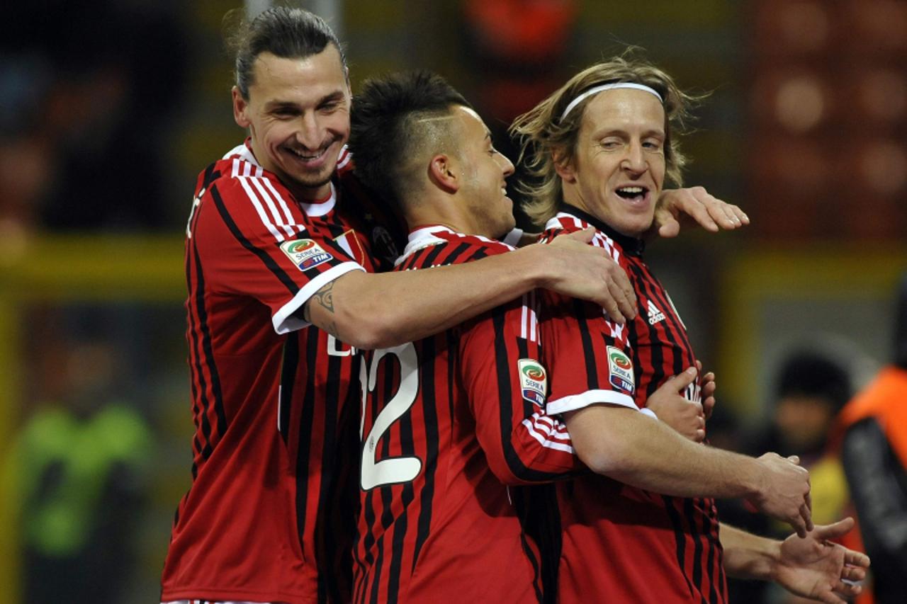 'AC Milan\'s Massimo Ambrosini (R) celebrates with his teammates Zlatan Ibrahimovic (L) and  Stephan El Shaarawy  after scoring against Cagliari during their Serie A soccer match at Giuseppe Meazza st