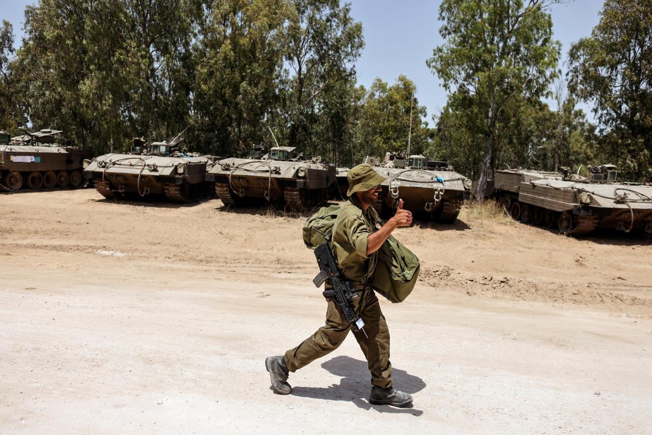 An Israeli soldier walks near the border between Israel and the Gaza Strip, on its Israeli side