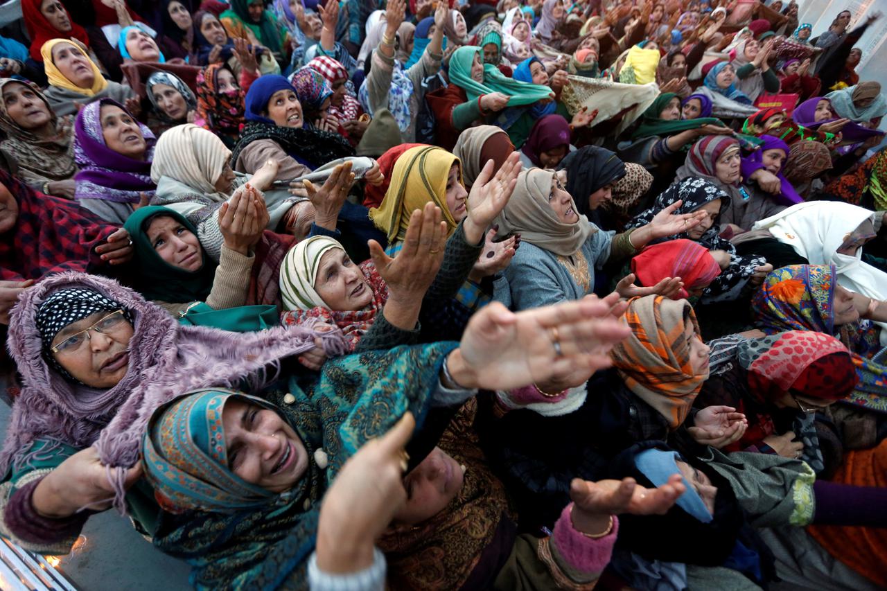 Kashmiri Muslim women react upon seeing a relic believed to be a hair from the beard of Prophet Mohammad, being displayed during the festival of Eid-e-Milad-ul-Nabi, the birthday anniversary of the prophet, at Hazratbal shrine in Srinagar December 12, 201