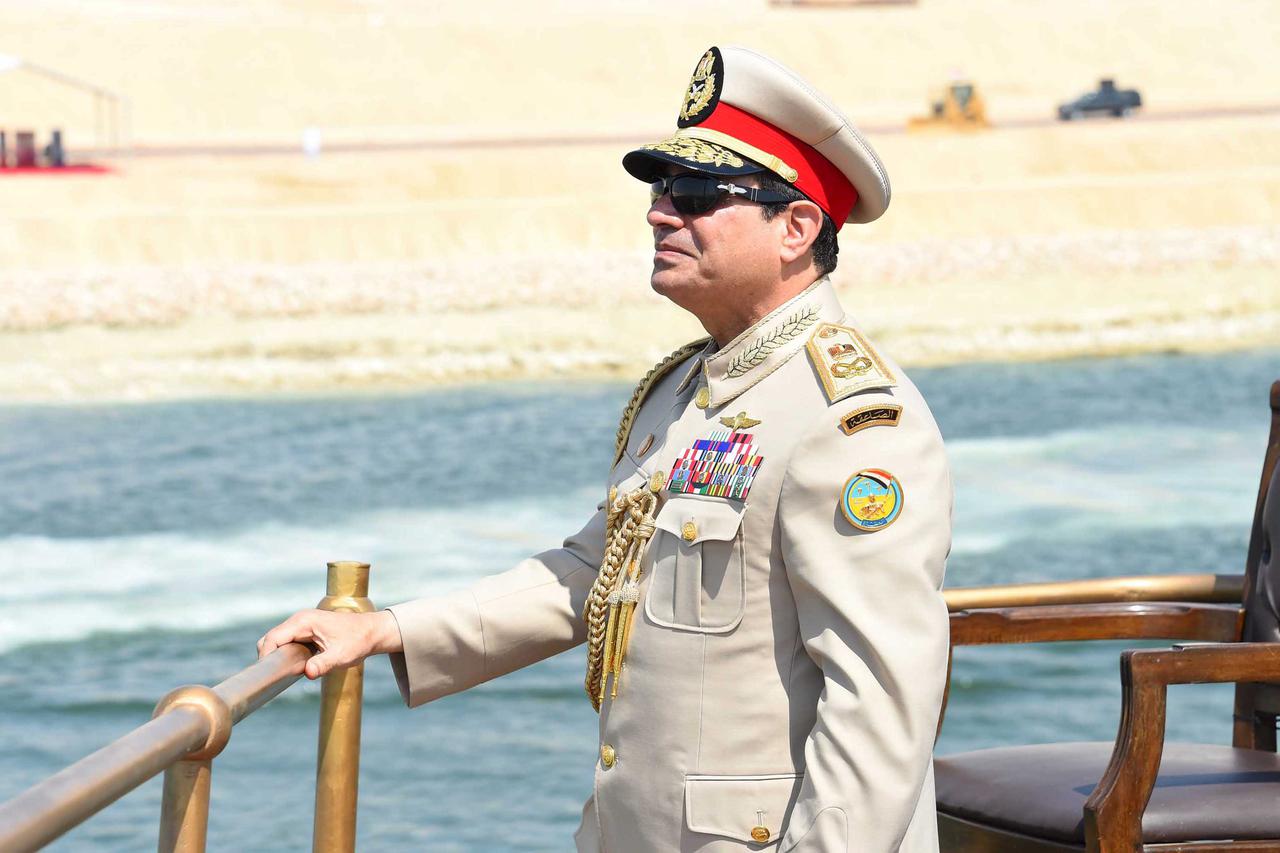 Egyptian President Abdel Fattah al-Sisi stands in boat on the Suez Canal as he attends the celebration of an extension of the Suez Canal in Ismailia, Egypt, August 6, 2015. Egypt will open an expansion to the Suez Canal to great fanfare on Thursday, the c
