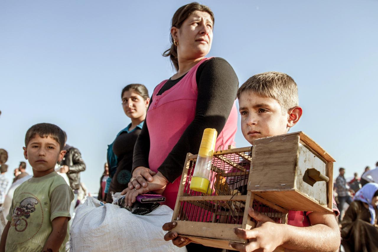 Residents of the Syrian city of Kobani (Arabic: Ain al-Arab) fled from attacks by the Islamic State (IS) over the border into Suruc, Turkey 30 September, 2014. They will be brought into refugee camps on trucks. Photo: Sebastian Backhaus/dpa - NO WIRE SERV