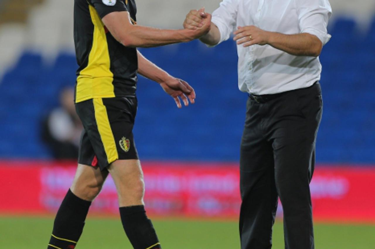 'Belgium Manager Marc Wilmots celebrates with scorer of their second goal Jan Vertonghen after their 2-0 win over Wales during the 2014 Fifa World Cup Qualifying match at the Cardiff City Stadium, Car