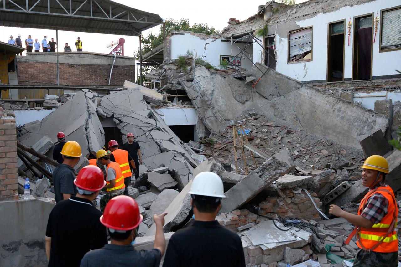 Rescue workers are seen at the site where a restaurant collapsed, in Xiangfen