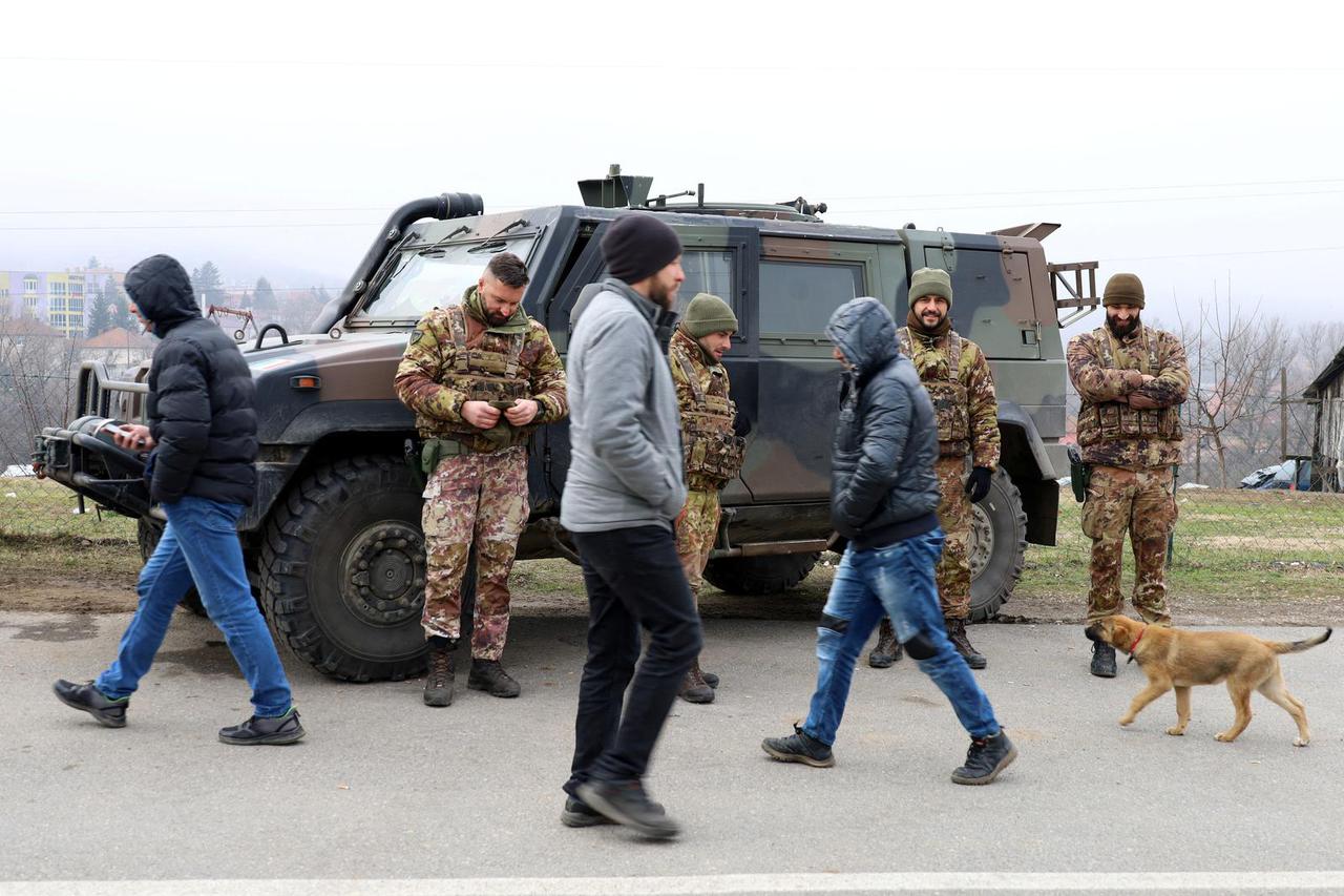 Members of the Italians Armed Forces, part of NATO peacekeepers mission in Kosovo, look on as local Serbs protest against the government near a roadblock in Rudare, near the northern part of the ethnically-divided town of Mitrovica