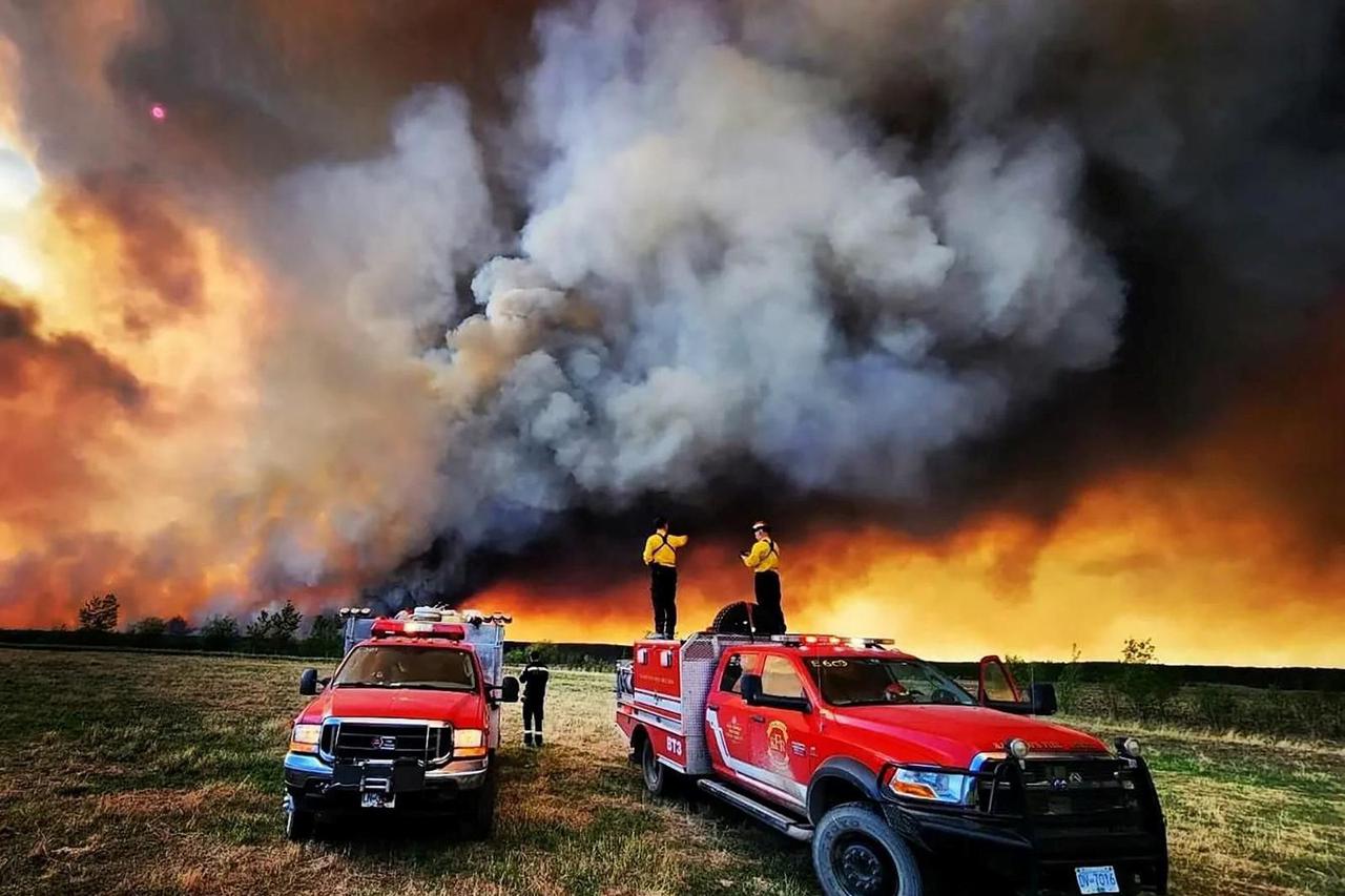 Firefighters from Kamloops Fire Rescue deploy to a wildfire near Fort St. John
