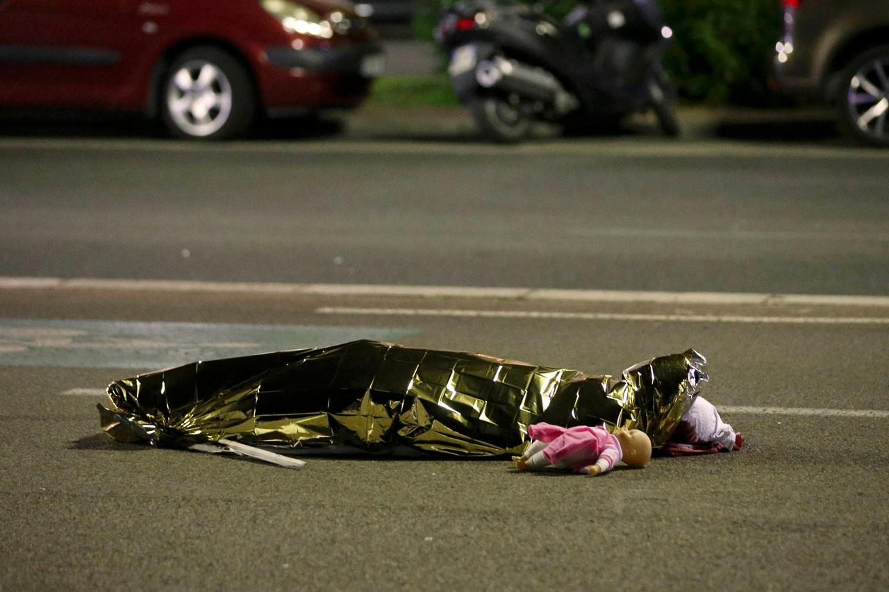 ATTENTION EDITORS - VISUAL COVERAGE OF SCENES OF INJURY OR DEATH - A body is seen on the ground in Nice, France July 15, 2016 after the Bastille Day truck attack by a driver who ran into a crowd on the Promenade des Anglais that killed scores on July 14. 