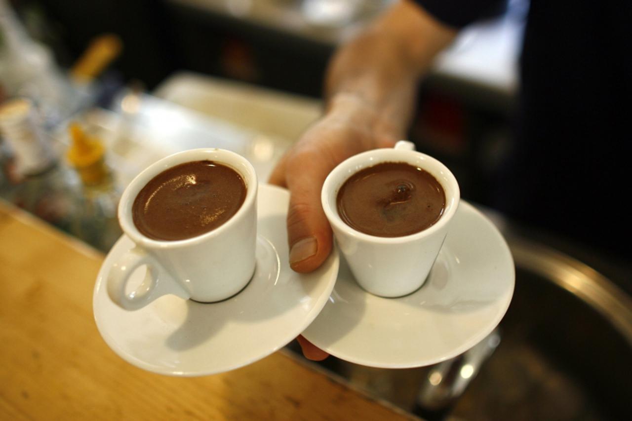 'A waiter carries two cups of Turkish coffee at a coffee shop in Istanbul October 19, 2007. Turks are turning their backs on traditional Turkish coffee as they acquire a taste for the cappuccinos and 