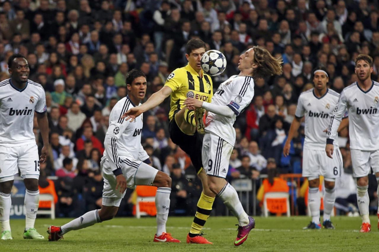 'Borussia Dortmund\'s Robert Lewandowski (center L) is challenged by Real Madrid\'s Luka Modric (center R) as team mates Raphael Varane, Karim Benzema, Sami Khedira and Sergio Ramos (L to R) look on  