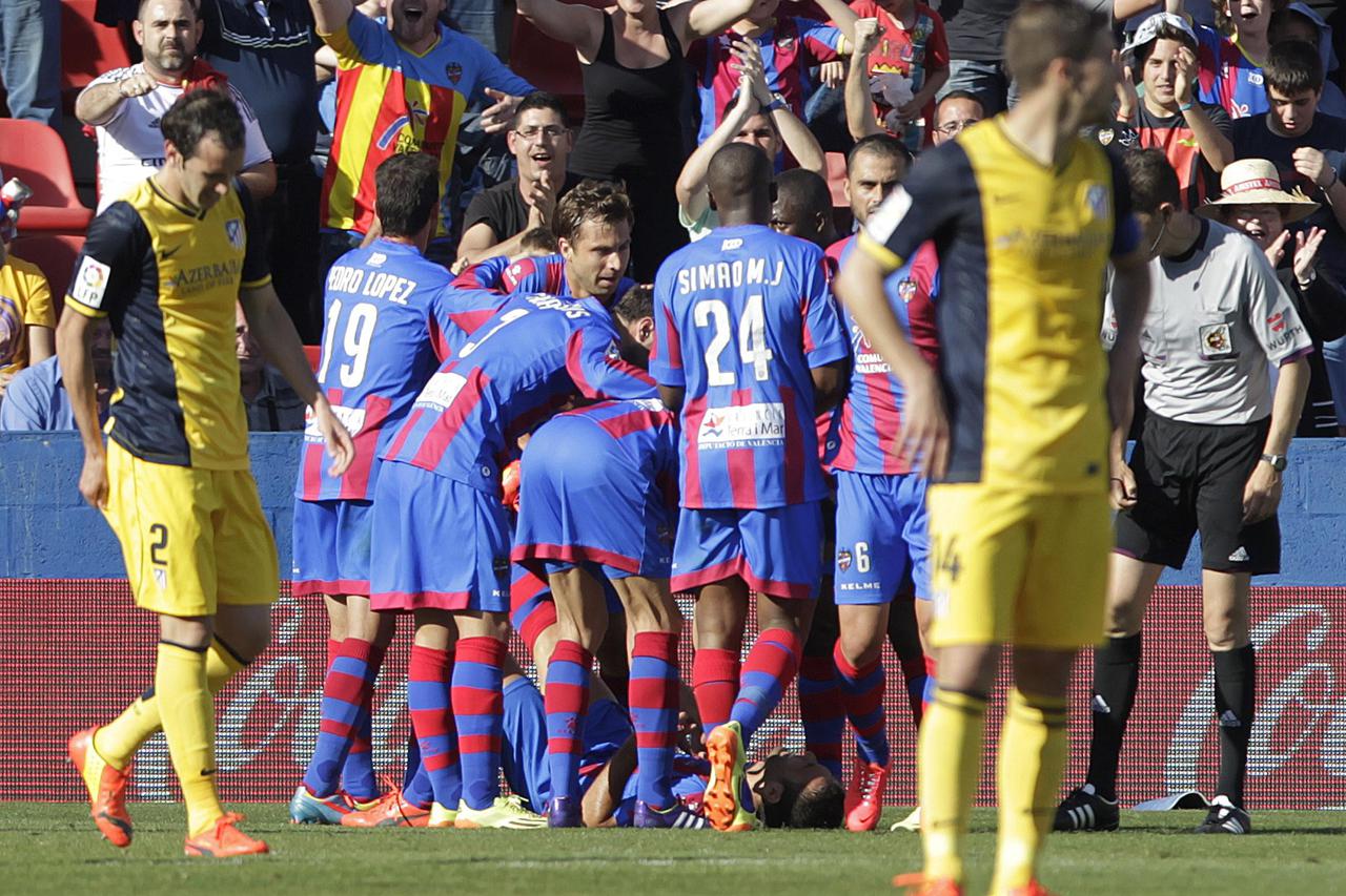 Levante's players celebrate after they scored against Atletico Madrid during their Spanish first division soccer match at the Ciudad de Valencia stadium in Valencia May 4, 2014. REUTERS/Heino Kalis (SPAIN - Tags: SPORT SOCCER)