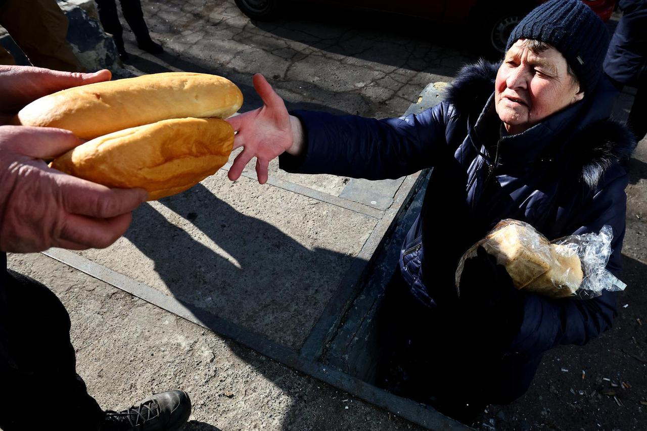 A resident receives bread from a food distribution in Chasiv Yar