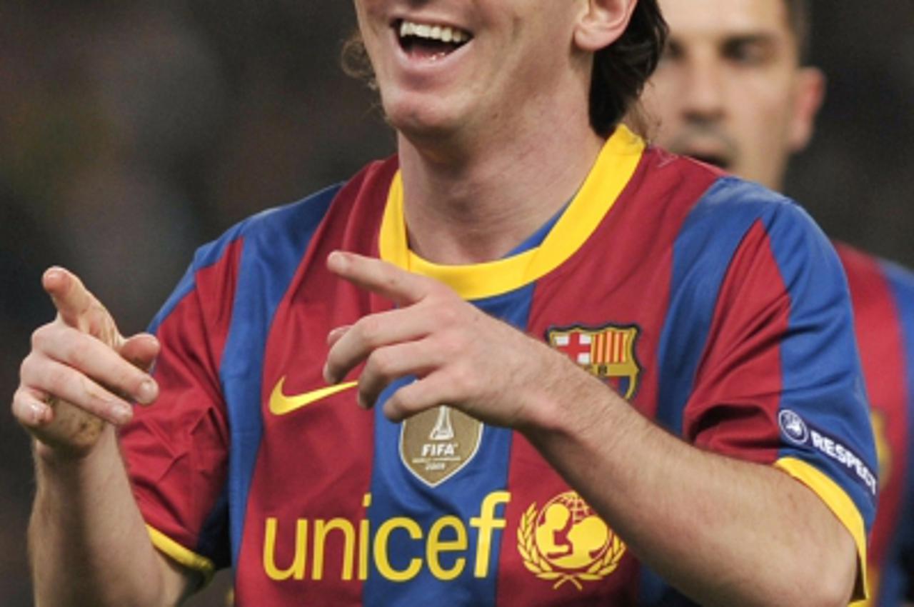 \'Barcelona\'s Lionel Messi celebrates after scoring against Panathinaikos Athens during their Champions League football match at the Olympic stadium in Athens on November 24, 2010. AFP PHOTO / LOUISA