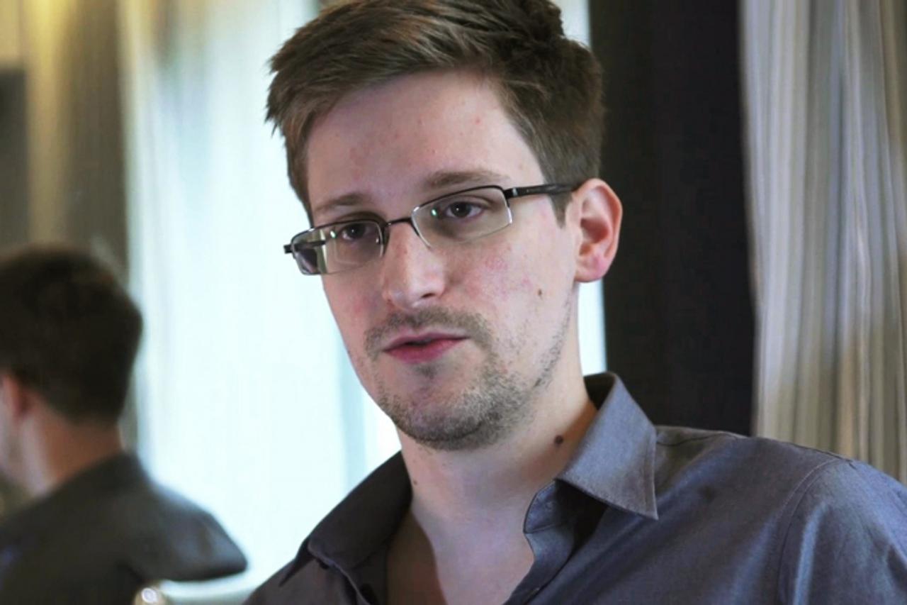 'NSA whistleblower Edward Snowden, an analyst with a U.S. defence contractor, is seen in this file still image taken from video during an interview by The Guardian in his hotel room in Hong Kong June 