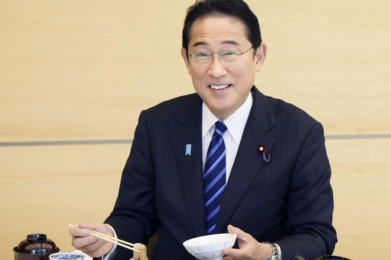 Japan's Prime Minister Fumio Kishida eats seafood from Fukushima Prefecture at a luncheon meeting, in Tokyo