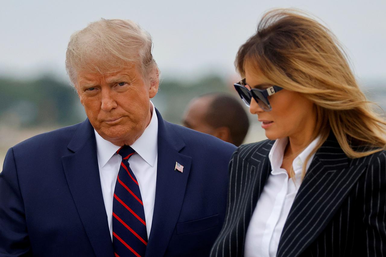 FILE PHOTO: U.S. President Donald Trump and first lady Melania Trump arrive at Cleveland Hopkins International Airport to participate in the first presidential debate with Democratic presidential nominee Joe Biden in Cleveland, Ohio