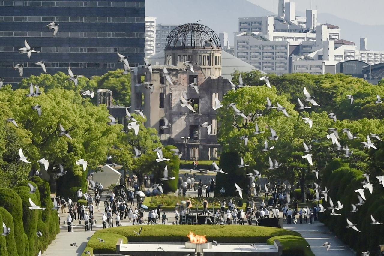 Birds fly over the Peace Memorial Park with a view of the gutted Atomic Bomb Dome on the 76th anniversary of the world's first atomic bombing in Hiroshima